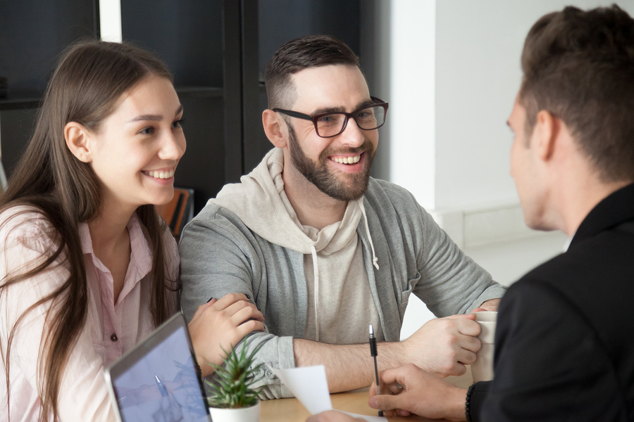 Excited Smiling Millennial Couple Discussing Retirement