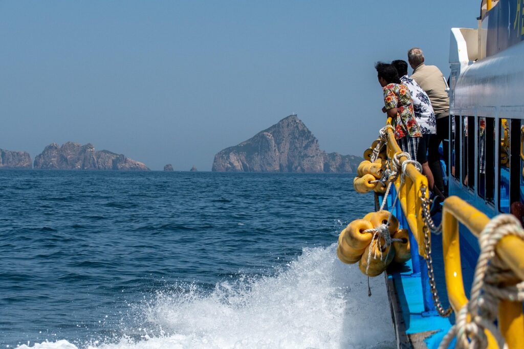 People on a boat heading for rocky islands. Planning for retirement