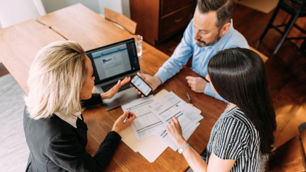 Couple discussing investing for retirement with a financial advisor.