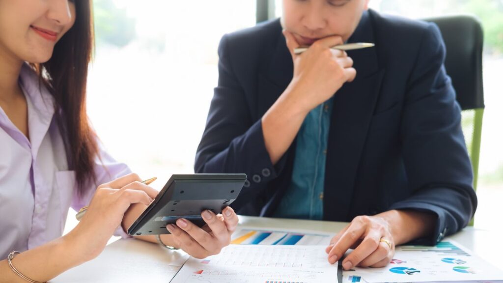 A bookkeeper consulting with a client about their accounts.